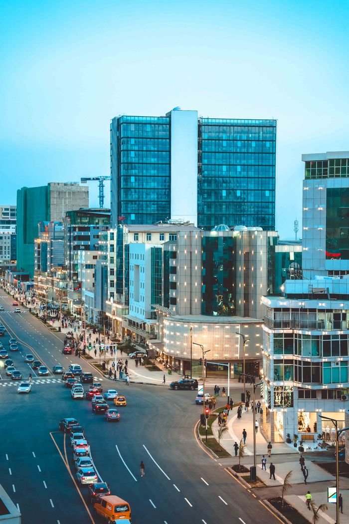 Services A bustling cityscape of Addis Ababa during the blue hour, showcasing modern architecture and busy streets.